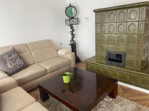 a living room with a couch and a coffee table at Erelia Cottage in Bük