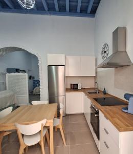 a kitchen with a wooden table and a dining room at Loft del Capataz in San Fernando