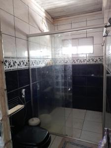a bathroom with a glass shower with a toilet at Casa Belém in Belém