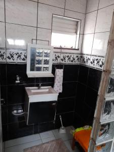 a bathroom with a sink and a mirror at Casa Belém in Belém