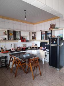 a kitchen with a table and chairs and a refrigerator at Casa Belém in Belém