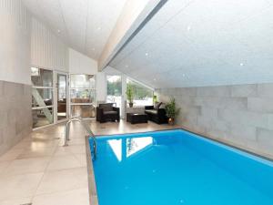 a swimming pool in a house with a living room at 14 person holiday home in L gst r in Trend