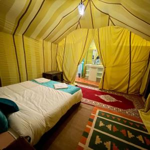 a bedroom with a bed in a tent at Exceptional Luxury Camp in Merzouga