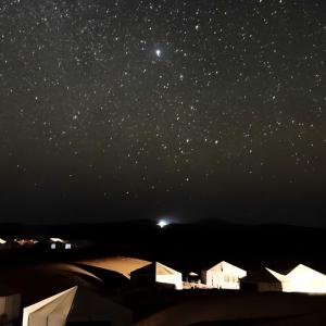 a starry night with the milky way and tents at Exceptional Luxury Camp in Merzouga