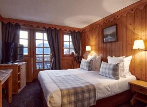 ムジェーヴにあるLa Ferme du Golfのベッドとテレビが備わるホテルルームです。