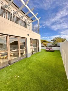 an image of a house with a lawn at Mountain Pearl Cottage in Hermanus