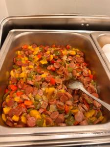 a pan filled with sausage and vegetables in an oven at Petra Premium Hotel in Wadi Musa