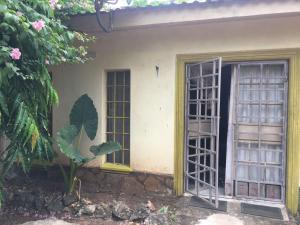 a house with two windows and a door at Tropical paradise in Mombasa