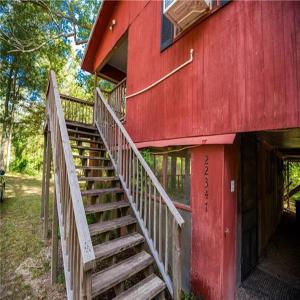a staircase leading up to a red building with a door at Brignac Camp in Robert