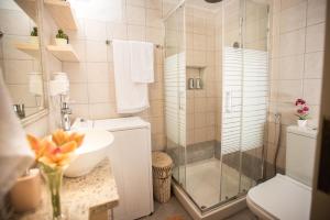 a bathroom with a shower and a sink and a toilet at Gifel - Luxury apartment in Kalamaki Heraklion +23 photos