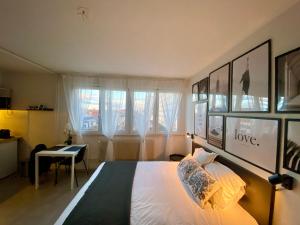 a bedroom with a bed and a desk in it at Travel Homes - Le Bright'N Cosy en pleine ville in Mulhouse