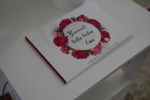 a heart shaped book on a table with a flower wreath at Il Posto per Te in Turi