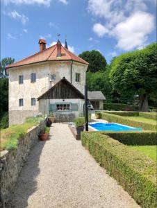 an external view of a building with a swimming pool at Medieval Castle in Kamnik City Center - Trutzturn in Kamnik