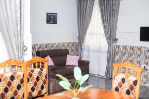 a living room with a couch and a table at Luxury Spacious Apartment in Kumasi