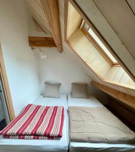 two beds in a small room in a attic at La Grangette de Paunac in Cazillac +12 photos