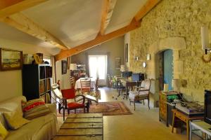 a living room with a couch and a table at Mas de la ferme du pont in Saint-Jean-de-Maruéjols-et-Avéjan