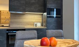 a kitchen with a table with two apples on it at Apartments Monika - Altenmarkt in Altenmarkt im Pongau