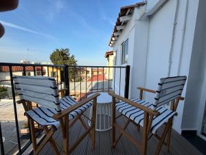 twee stoelen op het balkon van een huis bij Venus Seaview 2B, Rooftop, PRIME Location, Paphos in Paphos City