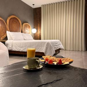 a room with a table with a tray of food and a bed at Hotel Zelva Negra in Medellín