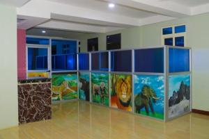 a room with paintings of animals on the wall at Jade Spa and Hotel in Kasese