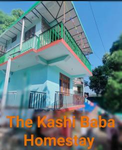 a house with a balcony and a banner that reads the kashkrit baja at The Kashi Baba Homestay in Dharamshala