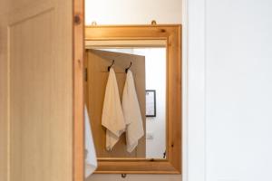 a mirror with two white towels hanging on it at The Dukes in Leighton Buzzard