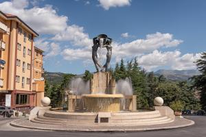 a statue in the middle of a street at La Tana della Volpe in Tempera