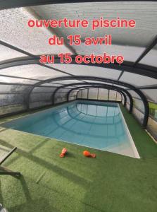an overhead view of a swimming pool in a building at Chalet de Fred in Saint-Ouen-de-Mimbré