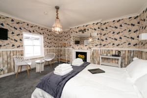 a bedroom with a large bed and a fireplace at Bosuns Chair in Lymington