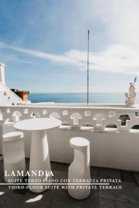a white table and white stools on a boat at Le Contrade Di San Salvatore in Monopoli