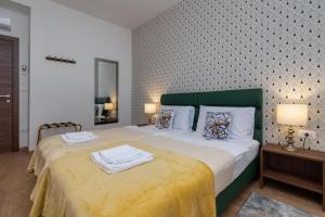 a bedroom with a large bed with towels on it at Aurora Rooms B&B Pula in Pula