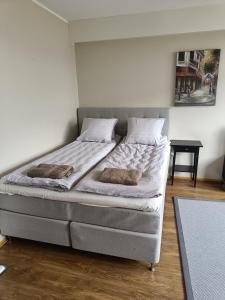 a bed with two pillows on it in a room at Lägenhet på markplan in Mariehamn +5 photos