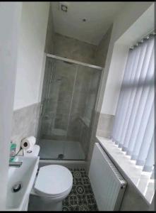 a bathroom with a shower and a toilet and a sink at Ensuite Double -bed L4 Burnley City Centre in Burnley