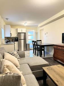 a living room with a couch and a table at modern rustic apartment in St. John's