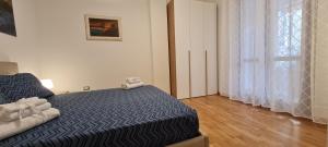 A bed or beds in a room at Gruppo Aedes Alghero, Residenza L'Isola - 200 mt dalla spiaggia