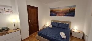 A bed or beds in a room at Gruppo Aedes Alghero, Residenza L'Isola - 200 mt dalla spiaggia