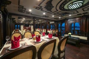 a dining car of a train with tables and chairs at Majestic Legend Cruise in Ha Long