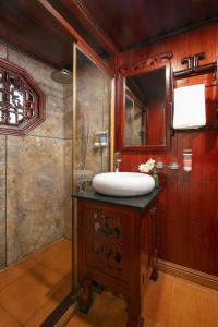 a bathroom with a sink and a mirror at Majestic Legend Cruise in Ha Long