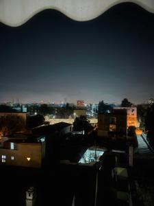 a view of a city at night at Sunset Apartment in Tirana +13 photos
