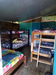 a room with three bunk beds in a room at Cabaña Murringo a dos minutos en coche de Necobotes en Necoclí in Necoclí +8 photos
