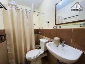 a bathroom with a toilet and a sink at JD Residence - 1 Bedroom Unit in Davao City