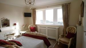 a bedroom with a bed and a fireplace and a window at Parkin House Guest House in Todmorden