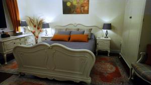a bedroom with a bed with orange pillows on it at Parkin House Guest House in Todmorden