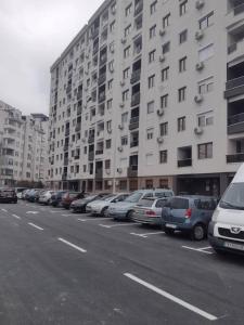 una fila de autos estacionados frente a edificios altos en F&M Apartment No 12, en Skopje