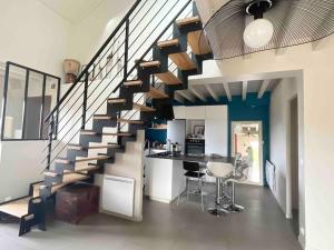 een woonkamer met een trap in een huis bij Maison entre lacs et fôrets in Montréal La Cluse