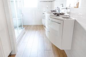 a white bathroom with a sink and a toilet at Abano Terme - La Dolce Vita's Villa (comfort & serenity) in Abano Terme +11 photos