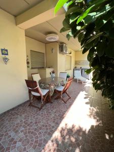 une pièce avec une table et des chaises et une cuisine dans l'établissement Casetta Anna, à Santa Marinella