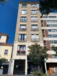 a tall building with balconies on the side of it at Apt Parisian Charm with Amazing View Near Metro in Asnières-sur-Seine