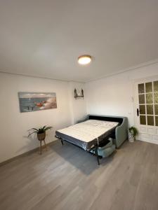 a bedroom with a bed in the corner of a room at EL MARINERITO Alcocebre in Alcossebre
