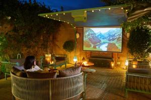 a woman sitting in a chair in front of a screen at Villa Taj Sofia & Spa in Marrakesh